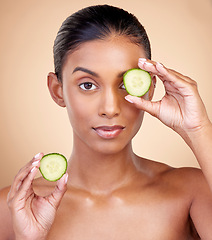 Image showing Cucumber, skincare and portrait of woman in studio, background or aesthetic shine. Face of indian female model, natural beauty and cooling fruits for sustainable cosmetics, healthy dermatology or spa