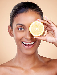 Image showing Lemon, beauty and portrait of happy woman in studio for vitamin c nutrition, spa or natural cosmetics. Face of indian female model, healthy skincare or citrus fruit in dermatology, vegan diet or glow