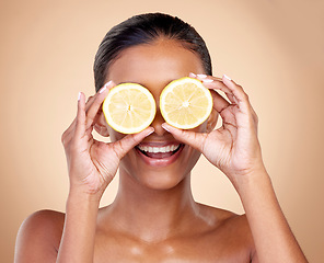 Image showing Face, skincare or happy woman with lemon for health, wellness or vitality isolated on studio background. Girl, smile or female model with natural citrus fruit for vitamin c, minerals or nutrition