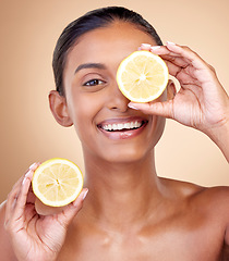 Image showing Lemon fruit, portrait and skincare of woman in studio for vitamin c benefits, eco cosmetics or nutrition. Face of indian female model, natural beauty and healthy citrus food for aesthetic dermatology