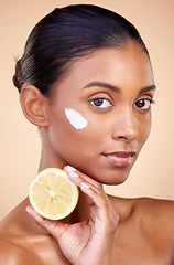 Image showing Woman, portrait and cream with lemon for skincare, cosmetics cleaning and natural beauty product or vitamin c benefits. Face of young person with fruits for dermatology on studio, brown background