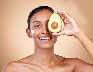 Image showing Avocado, cream and beauty with portrait of woman in studio for product, skincare and natural cosmetics. Spa, facial and lotion with face of model on brown background for vitamin c and self care