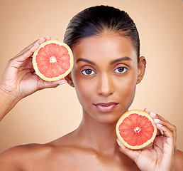 Image showing Grapefruit, portrait and beauty of woman in studio for vitamin c benefits, eco cosmetics and nutrition. Face of indian female model, natural skincare and healthy citrus food for aesthetic dermatology