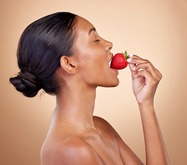 Image showing Woman, eating a strawberry and skincare with natural beauty or benefits from healthy nutrition, diet and fruit. Girl, profile and food with vitamin c for skin to glow, shine or wellness of body