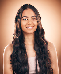 Image showing Face, curly hair and beauty of woman in studio isolated on a brown background. Hairstyle, natural cosmetics and portrait of happy model with salon treatment for balayage, growth and health aesthetic