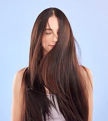 Image showing Luxury, texture and woman with hair care, cosmetics and wellness against a blue studio background. Female person, aesthetic and model with volume, wavy and scalp treatment with self care and beauty