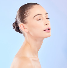 Image showing Woman, natural beauty and eyes closed in studio, blue background or facial wellness. Face, calm and young female model for skincare glow, aesthetic dermatology or cosmetics of self love, spa or shine