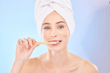 Image showing Beauty, dental and brushing teeth with portrait of woman in studio for wellness, self care and skincare. Product, shower and cleaning with person on blue background for cosmetics and oral hygiene