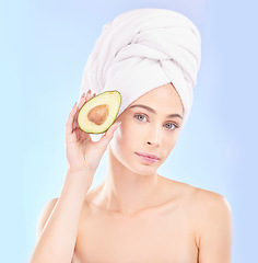 Image showing Woman, portrait and avocado, natural beauty and vitamin c with sustainable skincare isolated on blue background. Face, female model with fruit and eco friendly dermatology, cosmetic care in studio
