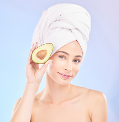 Image showing Skincare, beauty and portrait of woman with avocado, makeup and facial detox with smile on blue background. Health, wellness and sustainability, model withface cleaning and towel on head in studio.