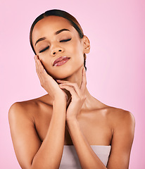 Image showing Woman, hands touching face and beauty with natural cosmetics and shine isolated on pink background. Female model, skin glow and dermatology with makeup, skincare and wellness with facial in a studio