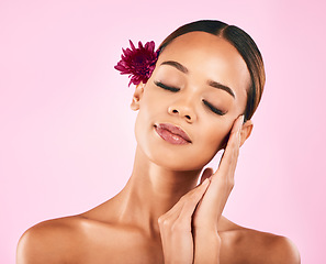 Image showing Woman, face and flower, natural beauty and eco friendly skincare with nature aesthetic on pink background. Female model, cosmetic and sustainable dermatology, makeup and organic facial in studio