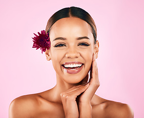 Image showing Natural beauty, flower and portrait of woman with makeup, wellness and skin care glow on pink background. Cosmetics, organic dermatology and model with luxury facial care and healthy spa in studio.