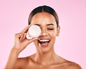 Image showing Happy woman, cream in container and beauty, skincare and moisturizer dot on face on pink background. Natural cosmetics, self care and lotion, sunscreen and dermatology with female model in studio