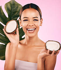 Image showing Woman, smile and coconut, natural beauty and palm leaf with sustainable skincare isolated on pink background. Happiness, female model with fruit and eco friendly dermatology, cosmetic care in studio