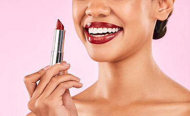 Image showing Lipstick, red lips and woman with smile, beauty and skin with makeup closeup isolated on pink background. Female model, cosmetic product and shine, happiness and cosmetology with glow in studio