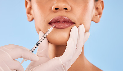 Image showing Lip filler, injection and beauty, woman and cosmetic surgery closeup and dermatology on blue background. Face, skincare and syringe, female model and doctor hands with liquid collagen in studio