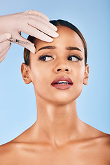 Image showing Skin injection, woman and concern of plastic surgery and collagen skincare in studio. Needle, beauty and female person with blue background with cosmetics, filler and wellness for dermatology