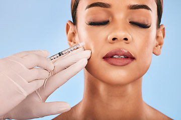 Image showing Face, injection and beauty, woman and cosmetic surgery and dermatology isolated on blue background. Antiaging, skincare and syringe, female model and doctor hands with liquid collagen in studio