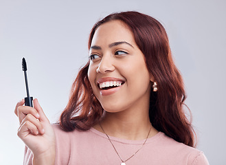 Image showing Smile, beauty or happy girl with mascara makeup, cosmetics or product brush laughing in studio. Woman, face or female model with eyelashes tool for grooming, glamour or self care on white background