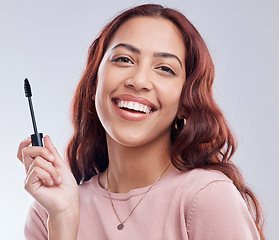 Image showing Portrait, beauty or happy girl with mascara makeup, cosmetics or product brush laughing in studio. Smile, face or woman model smiling with eyelashes tool for make up or self care on white background