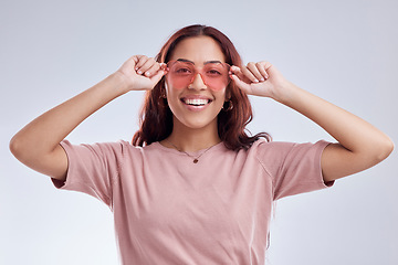 Image showing Woman, portrait and fashion sunglasses with smile, vision and retro isolated on white background. Happy female person, gen z and funky style, vintage and cool eyewear with stylish accessory in studio