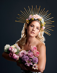 Image showing Woman, flowers and crown in studio portrait for goddess, beauty or wellness for new beginning by black background. Girl, model and bouquet with plants, makeup and aesthetic for growth with cosmetics