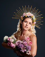 Image showing Woman, spring goddess and studio portrait with flowers, beauty and crown for new beginning by black background. Girl, model and bouquet with plants, makeup and aesthetic for growth with cosmetics