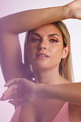 Image showing Portrait, skincare and makeup with a model woman in studio on a gray background in red lighting for desire. Face, beauty or cosmetics with a young female person posing for natural feminine confidence