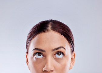 Image showing Looking up, mockup or woman thinking of idea in studio isolated on white background to promote beauty. Marketing, natural glowing skincare or face of female model with mock up space for advertising