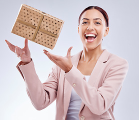 Image showing Gift, happy and portrait of business woman in studio for shopping, surprise and birthday celebration. Wow, giveaway and prize with face of person and box on white background for package and present