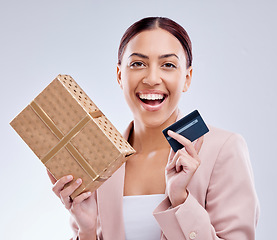 Image showing Woman, credit card and gift box for prize, retail giveaway or payment success on studio white background. Happy person or winner portrait with present, finance bonus and shopping sale and e commerce