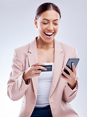 Image showing Happy woman, credit card and smartphone for online shopping, excited about deal and fintech on white background. Female customer, smile with payment and e commerce, bank app and discount in studio