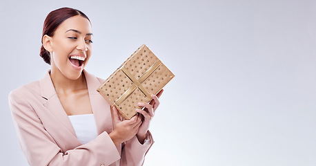 Image showing Woman, wow and gift box for prize, giveaway celebration and surprise on studio, white background and banner mockup. Excited person or winner with present, package and retail shopping or competition