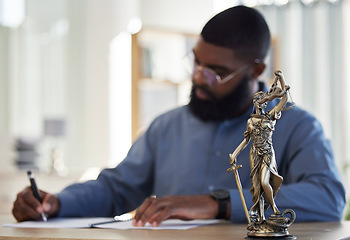 Image showing Lawyer, office and man at desk with statue of justice, contract or documents for court schedule. Consultant, law firm attorney or judge with signature paperwork for legal agreement or deal in Africa.