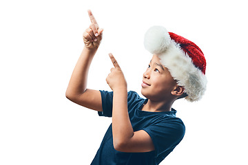 Image showing Christmas, pointing and happy with child on transparent background for celebration, advertising and show. Promotion, festive holiday and xmas with young boy isolated on png for hand gesture and deal