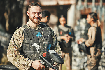 Image showing Paintball game, portrait and happy man in battlefield, challenge or military mission, gun fight or conflict. Happiness, soldier smile and male player ready for war training, action or battle training