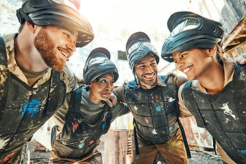 Image showing Paintball, happy team and meeting in huddle for game plan, collaboration or strategy on battle field together. Group of paintballers smile in war discussion, teamwork or motivation before match start