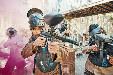 Image showing Teamwork, shooting and paintball with man in game for playground, war and gaming. Challenge, mission and soldier with people and smoke in battlefield arena for target, gun and warrior training