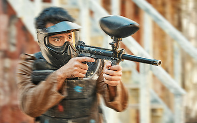 Image showing Paintball, sports and man in action with blur for tournament, competition and battle in nature. Target, military and male person shooting in outdoor arena for training, adventure games and challenge