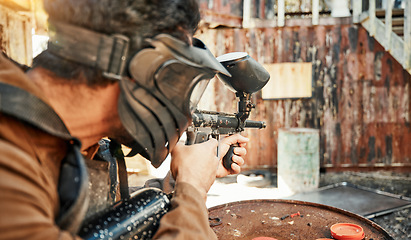 Image showing Paintball, training and man aim with gun for tournament, competition and target practice in nature. Sports, military and male person shooting in outdoor arena for action, adventure game and challenge