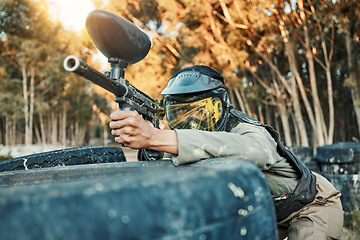 Image showing Paintball, sports and person in action with gun for tournament, competition and battle in nature. Camouflage, military and woman shooting in outdoor arena for training, adventure games and challenge