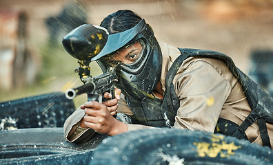 Image showing Paintball, sports and woman in action with gun for tournament, competition or battle in park. Soldier, military and female person shooting in outdoor arena for training, adventure games and challenge