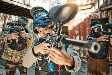 Image showing Paintball team, gun and woman focus on player challenge, target aim or military conflict, fight or soldier mission. Group, serious or people pointing weapon in survival war, action or battle training