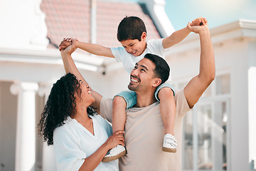 Image showing Happy, love and young family bonding outdoor in the backyard of their modern house. Happiness, smile and boy child playing with his parents in the outside garden for fresh air by their new home.