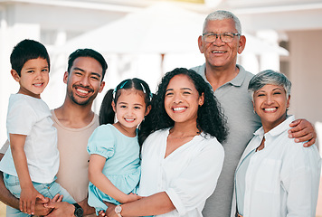 Image showing Happy, excited and portrait of big family together in the backyard of their modern house. Happiness, smile and children bonding and posing with their grandparents and parents in garden by their home.