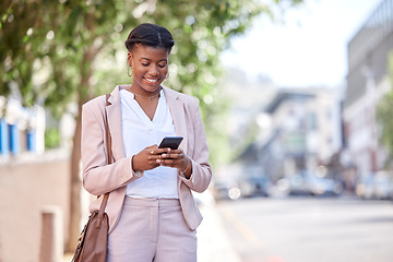 Image showing Business woman, phone and typing outdoor on a city road for communication, network or chat. Black female entrepreneur with a smartphone on a sidewalk for internet connection, message or travel app