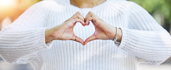 Image showing Love, heart and peace with hands of woman in nature for support, motivation and kindness. Thank you, lens flare and hope with closeup of person and sign in outdoors for emoji, health and banner