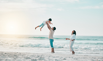 Image showing Beach, family and father lifting boy child with love, freedom and travel celebration in nature. Flying, fun and parents with kid at the ocean for bond, happy and airplane game while traveling in Bali