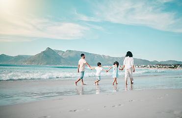 Image showing Holding hands, walking and family and the beach from behind with freedom, vacation and fun at sea. Ocean and children with parents in Hawaii for travel, bond and summer holiday on sky mockup space
